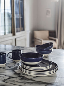 Indigo Cereal bowls, mugs, and plates on marble table top
